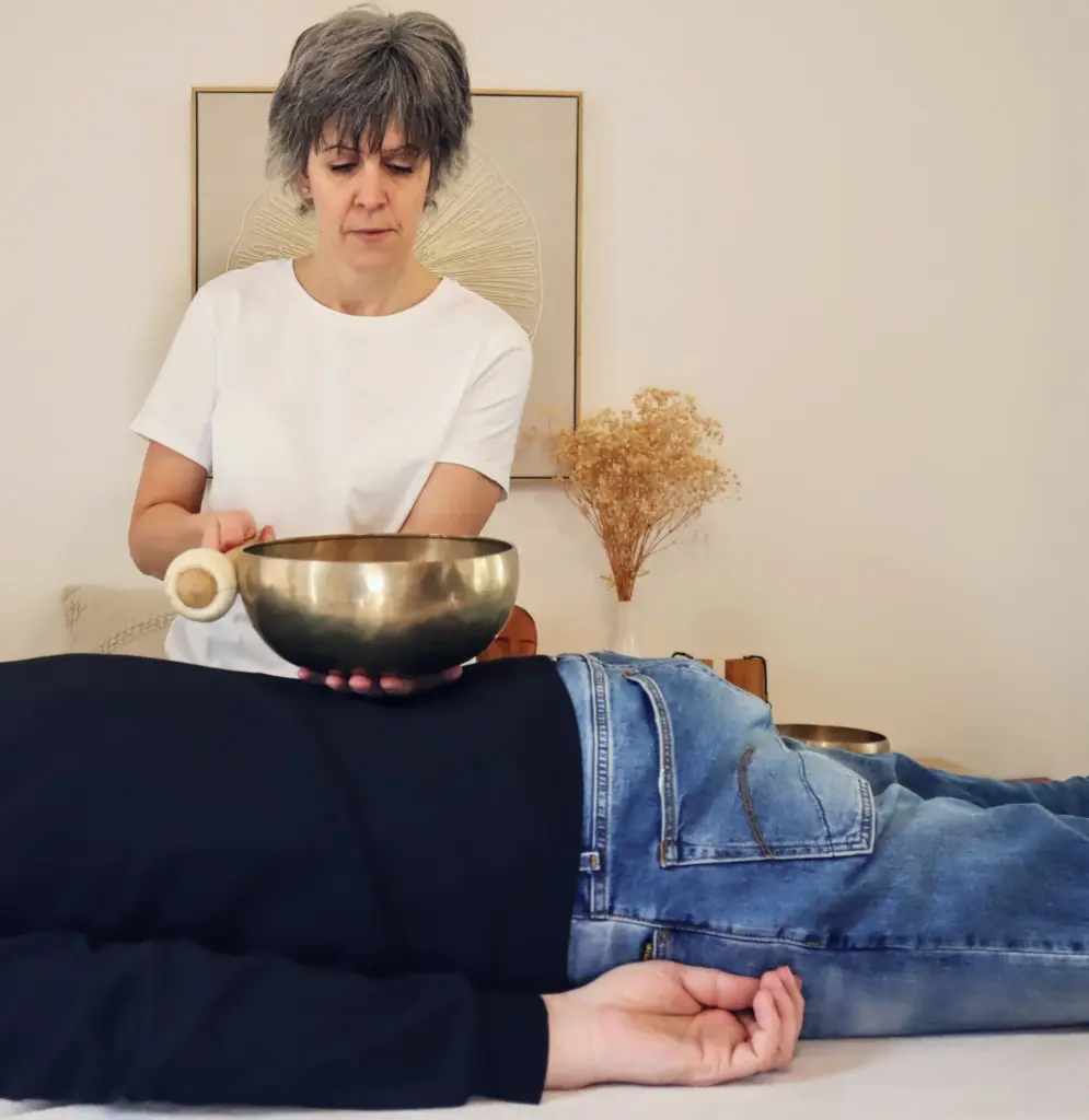 Person receiving a sound bowl therapy session