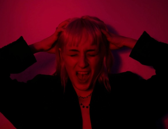 Person holding the head and shouting in frustration and fear