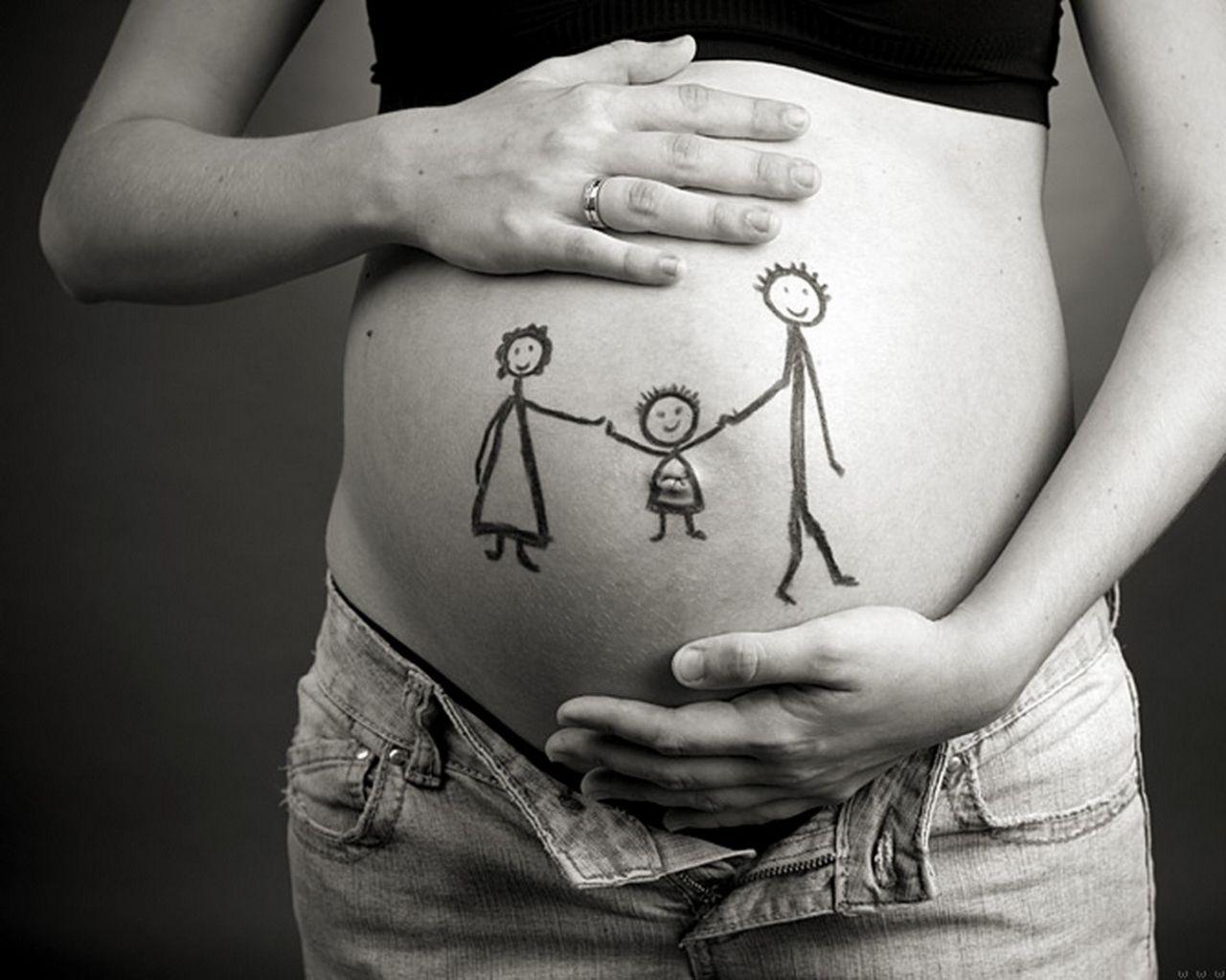 Pregnant belly with a childlike drawing of a family
