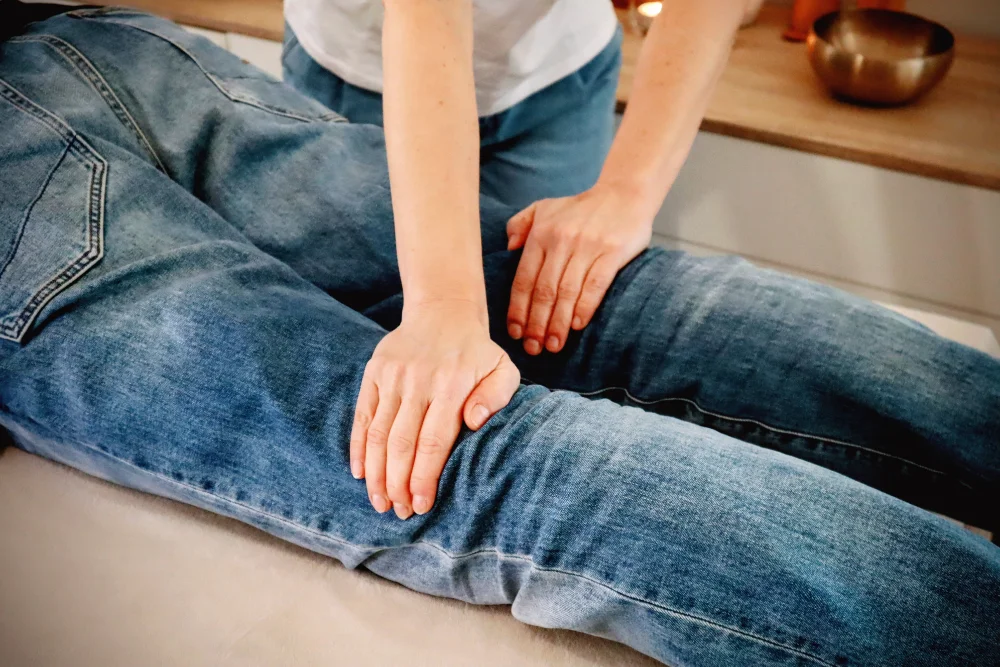 Hands massaging a person’s knee