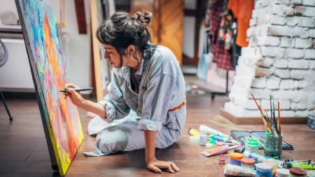 Person painting on canvas