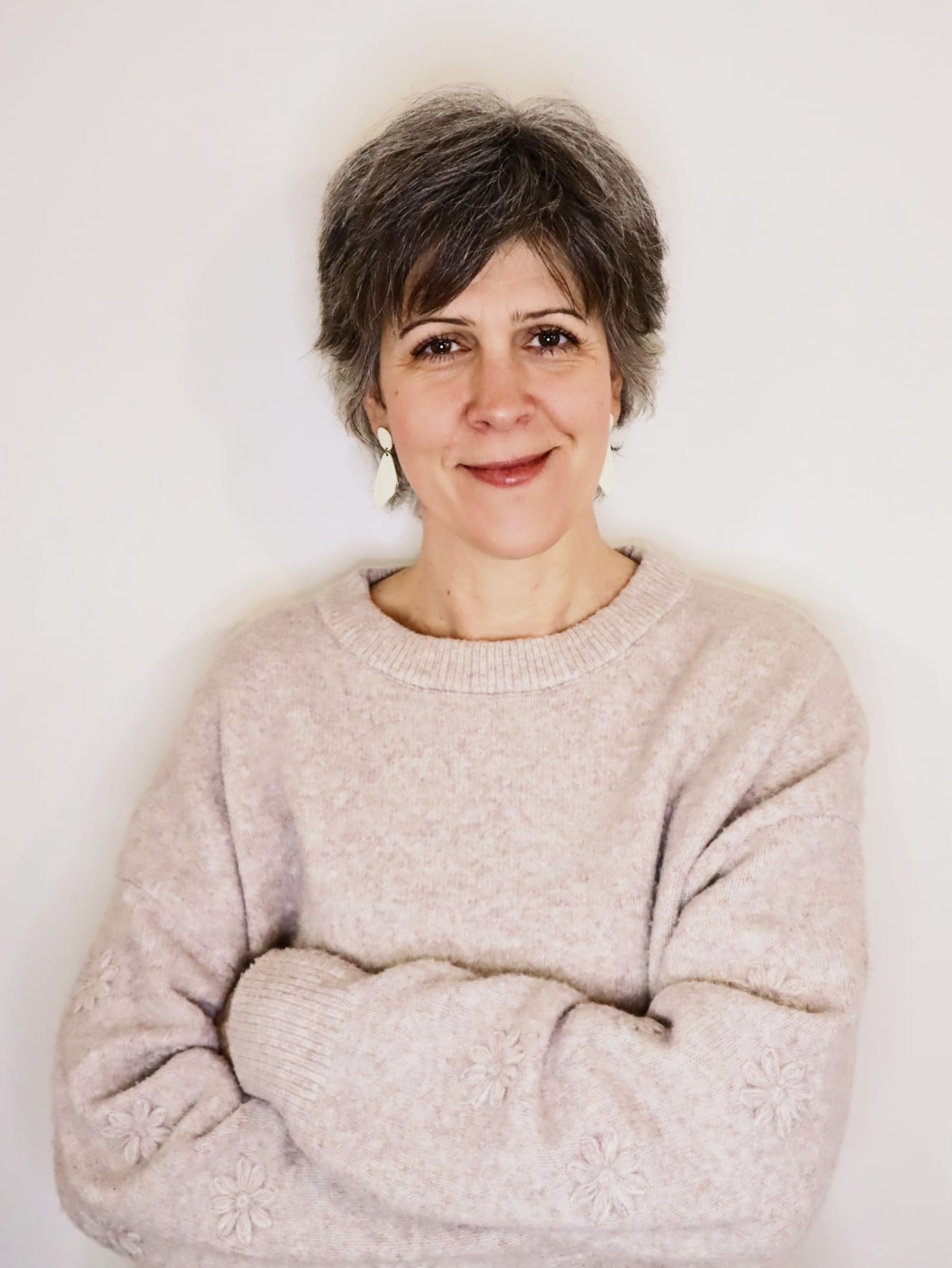 Portrait of a smiling middle-aged woman with crossed arms